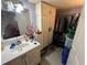 Bathroom with a single vanity, tiled floor, storage and open closet at 2539 Dogwood Hills Ct, Austell, GA 30106