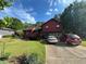 Charming red two-story home featuring a stone facade, a well-maintained lawn, and a private driveway at 2539 Dogwood Hills Ct, Austell, GA 30106