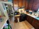 A compact kitchen with modern appliances, wood cabinets, and practical layout at 2539 Dogwood Hills Ct, Austell, GA 30106