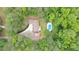 Aerial view of the property highlighting the pool and surrounding trees at 320 Williamsburg Cir, Mcdonough, GA 30253