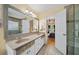 Bathroom with double sinks, granite countertop, and oversized mirror, leading to bedroom at 320 Williamsburg Cir, Mcdonough, GA 30253