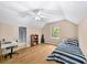 Bedroom featuring hardwood floors, a ceiling fan, and lots of natural light at 320 Williamsburg Cir, Mcdonough, GA 30253