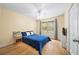 Cozy bedroom with hardwood floors, ceiling fan, and window with natural light at 320 Williamsburg Cir, Mcdonough, GA 30253