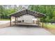 Large metal carport next to house at 320 Williamsburg Cir, Mcdonough, GA 30253