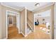 Entryway featuring hardwood floors, staircase, and hallway leading to living room at 320 Williamsburg Cir, Mcdonough, GA 30253