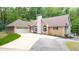 Charming brick home featuring an attached garage and well-maintained landscaping at 320 Williamsburg Cir, Mcdonough, GA 30253