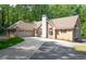 Charming brick home featuring an attached garage and well-maintained landscaping at 320 Williamsburg Cir, Mcdonough, GA 30253