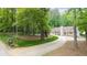 Inviting home nestled among mature trees with a long driveway at 320 Williamsburg Cir, Mcdonough, GA 30253