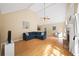 Bright living room with vaulted ceilings, hardwood floors, fireplace, and comfortable blue sectional sofa at 320 Williamsburg Cir, Mcdonough, GA 30253