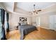 Spacious main bedroom with tray ceilings, hardwood flooring, and ample natural light at 320 Williamsburg Cir, Mcdonough, GA 30253