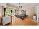 Large main bedroom with trey ceiling, hardwood floors, french doors to porch, and a crib at 320 Williamsburg Cir, Mcdonough, GA 30253