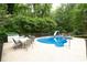 In-ground pool with a slide and patio furniture for outdoor entertaining at 320 Williamsburg Cir, Mcdonough, GA 30253