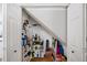 View of an under-stair storage space with white shelving and double doors at 320 Williamsburg Cir, Mcdonough, GA 30253