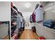 Walk-in closet with clothing racks and shelving on both sides at 320 Williamsburg Cir, Mcdonough, GA 30253