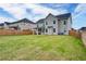 A big backyard with green grass and a wooden fence gives privacy at 3236 Papyrus Palm Rd, Loganville, GA 30052