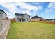 Expansive backyard featuring a well-maintained lawn and privacy fence at 3236 Papyrus Palm Rd, Loganville, GA 30052