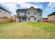 Large, fenced backyard with a covered patio, perfect for outdoor entertaining at 3236 Papyrus Palm Rd, Loganville, GA 30052