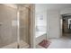Bright bathroom showcases a glass enclosed shower and separate soaking tub for a relaxing experience at 3236 Papyrus Palm Rd, Loganville, GA 30052