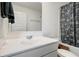 Bright bathroom features a white vanity, large mirror, and shower with decorative curtain at 3236 Papyrus Palm Rd, Loganville, GA 30052