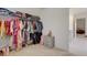 Organized walk-in closet with ample hanging space and shelving for all your storage needs at 3236 Papyrus Palm Rd, Loganville, GA 30052