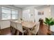 Bright dining room with a wooden table and upholstered chairs, with front door access at 3236 Papyrus Palm Rd, Loganville, GA 30052