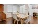 Bright dining room with a wooden table, upholstered chairs and a wooden china cabinet at 3236 Papyrus Palm Rd, Loganville, GA 30052