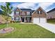 Charming two-story brick home with a well-manicured lawn and a two-car garage at 3236 Papyrus Palm Rd, Loganville, GA 30052
