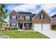 Beautiful two-story brick home with a well-manicured lawn and a two-car garage at 3236 Papyrus Palm Rd, Loganville, GA 30052