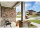 Cozy front porch with decorative stone pillars and beautiful floral arrangements at 3236 Papyrus Palm Rd, Loganville, GA 30052