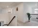 Upstairs hallway with carpet and railing, leading to rooms and offering natural light at 3236 Papyrus Palm Rd, Loganville, GA 30052