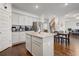 Modern kitchen with granite countertops, stainless appliances, and an island with bar seating and a dining area at 3236 Papyrus Palm Rd, Loganville, GA 30052