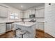 Kitchen features stainless appliances, an island with bar seating, and beautiful granite countertops at 3236 Papyrus Palm Rd, Loganville, GA 30052