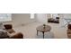 Spacious living room features neutral carpet, light walls, plus brown sofas and a round table at 3236 Papyrus Palm Rd, Loganville, GA 30052