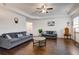 Open-concept living room featuring hardwood floors, neutral walls and two sofas at 3236 Papyrus Palm Rd, Loganville, GA 30052