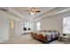 Large bedroom with neutral carpet, a ceiling fan, and access to a connected living space at 3236 Papyrus Palm Rd, Loganville, GA 30052
