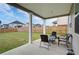 Covered patio with outdoor seating overlooks a spacious, fenced backyard at 3236 Papyrus Palm Rd, Loganville, GA 30052