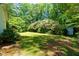 Private backyard with lush greenery, mature trees, and storage shed at 3605 Sewell Mill Rd, Marietta, GA 30062
