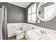 Classic bathroom with pedestal sink, wainscoting, and tiled floor at 3605 Sewell Mill Rd, Marietta, GA 30062