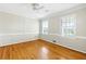 Airy bedroom with hardwood floors, large windows, and classic trim at 3605 Sewell Mill Rd, Marietta, GA 30062