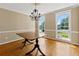 Elegant dining room featuring hardwood floors, large windows, and a classic chandelier at 3605 Sewell Mill Rd, Marietta, GA 30062