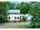 Inviting two-story home with a classic white facade, black shutters, and a meticulously maintained front yard at 3605 Sewell Mill Rd, Marietta, GA 30062