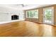 Bright living room with hardwood floors, a white brick fireplace, and a glass door leading to the outdoors at 3605 Sewell Mill Rd, Marietta, GA 30062