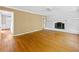 Spacious living room featuring hardwood floors, white brick fireplace, and ceiling fan at 3605 Sewell Mill Rd, Marietta, GA 30062