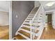 Interior view of a staircase with wooden treads, white risers, and a gray accent wall at 3605 Sewell Mill Rd, Marietta, GA 30062