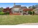 Spacious backyard with a deck, patio, and mature landscaping offering outdoor living and entertaining at 44 Kingsford Xing, Acworth, GA 30101