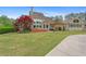 View of the large backyard with deck, patio, mature trees, and well-maintained lawn at 44 Kingsford Xing, Acworth, GA 30101