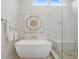 Bright bathroom featuring a soaking tub, glass shower, and decorative wall art at 44 Kingsford Xing, Acworth, GA 30101
