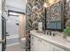 Charming bathroom boasts a modern sink, stylish floral wallpaper, and well-lit mirror, perfect for any home at 44 Kingsford Xing, Acworth, GA 30101