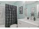 Elegant bathroom featuring a white vanity, large mirror, and a shower with a gray curtain at 44 Kingsford Xing, Acworth, GA 30101