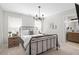 Well-lit bedroom with a wrought iron bed frame, natural nightstands, and view to the bathroom at 44 Kingsford Xing, Acworth, GA 30101